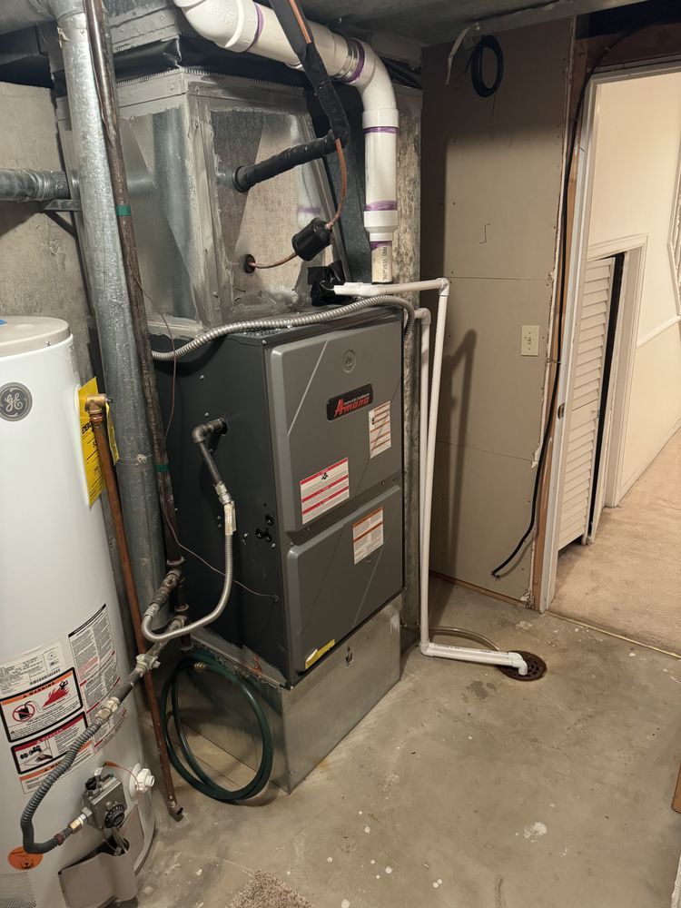 A high-efficiency Amana gas furnace with PVC venting installed in a basement by Temperature Select Air.