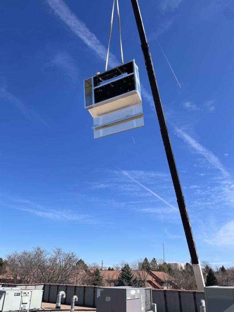 A crane lifts rooftop HVAC equipment into place during a commercial installation by Temperature Select Air.