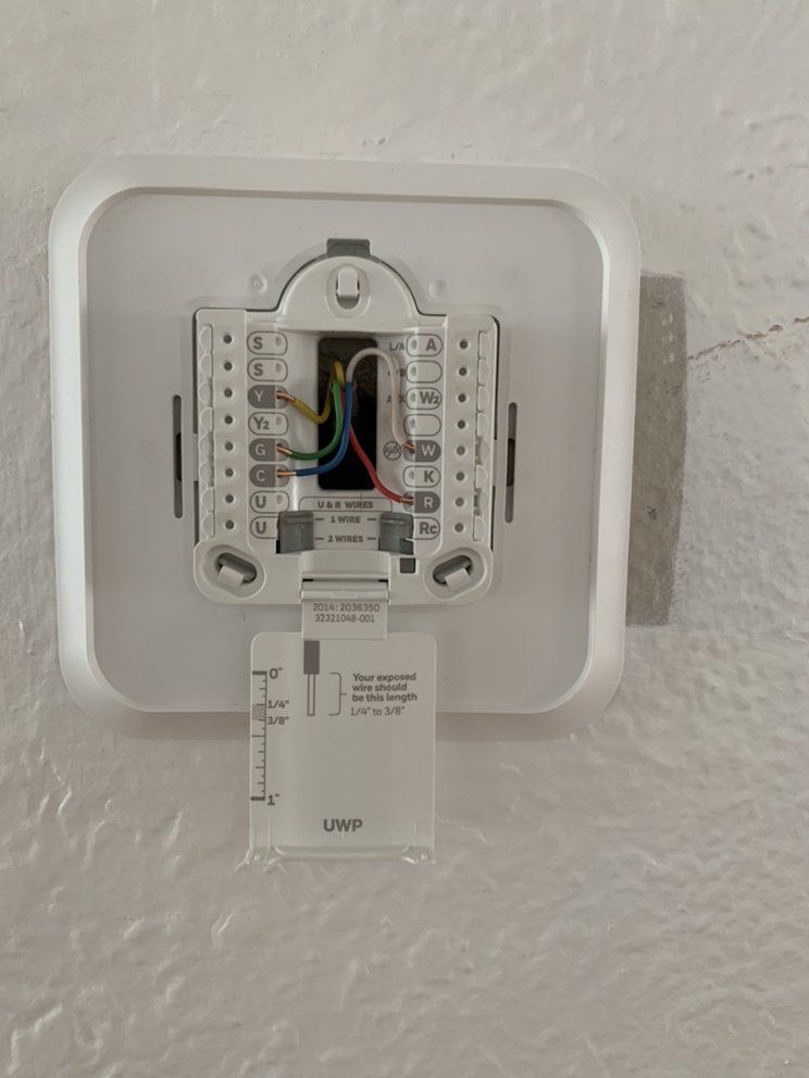 A Honeywell thermostat wall plate wired during installation by Temperature Select Air.
